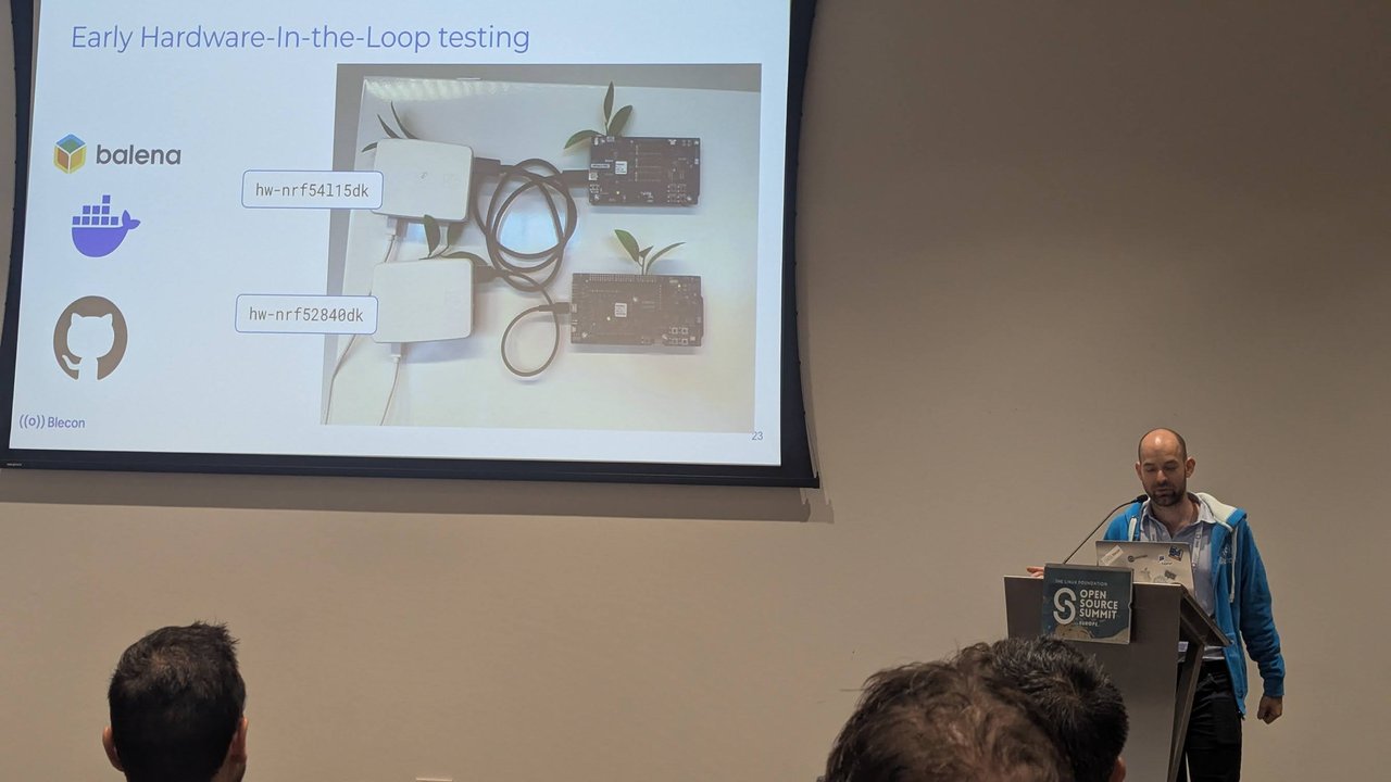 Blecon talk at Embedded Linux Conference Europe 2025: Early Hardware-In-the-Loop testing slide with balena and nRF development kits, speaker at the podium