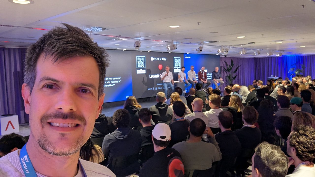 Luca Berton in the audience at AI House Amsterdam with the Lets talk OpenClaw stage screens behind him