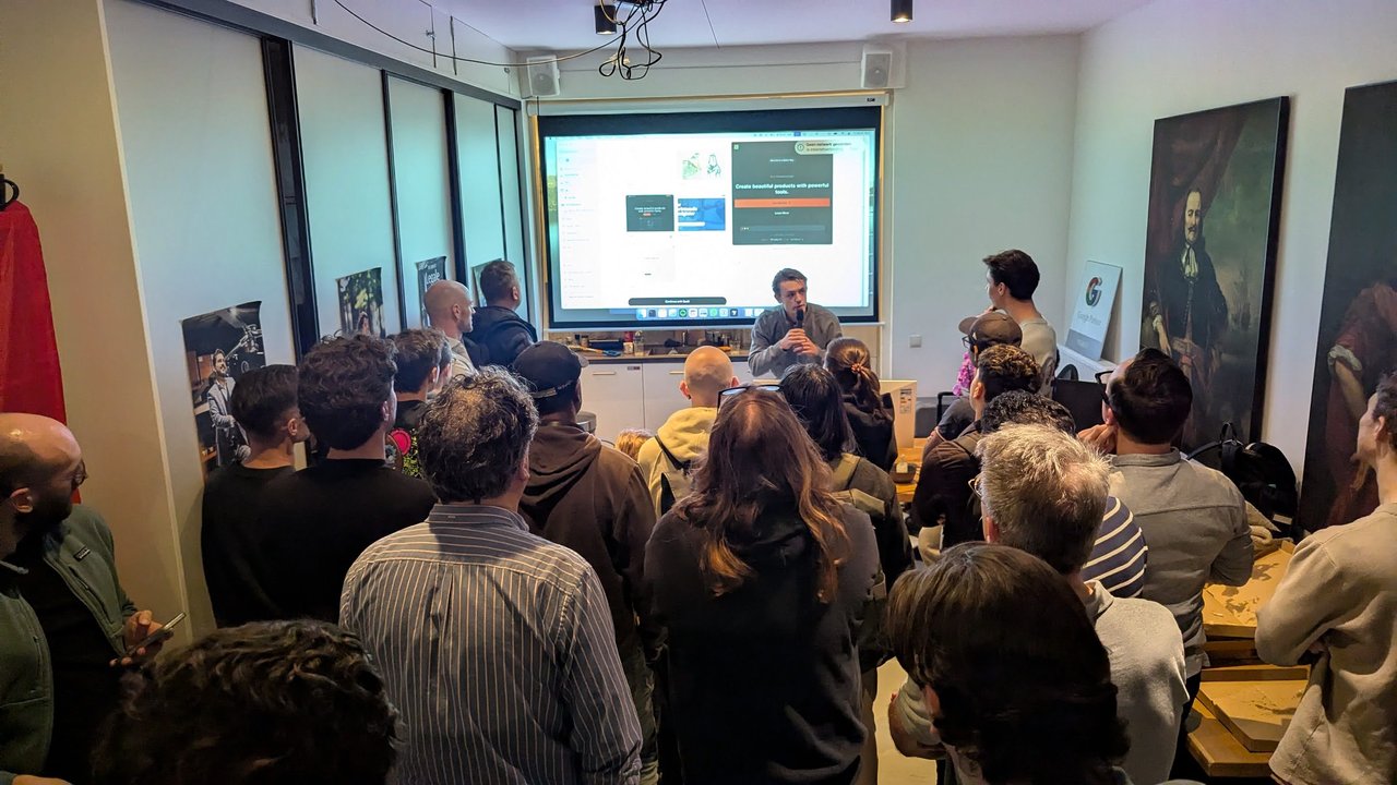 A builder at the front of the room demoing a web app at the OpenClaw Demo + Hackathon Amsterdam, with pizza boxes on the side