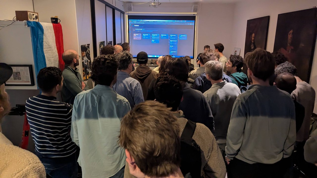 Attendees standing shoulder to shoulder at the back of the room, watching a demo on the projector at the OpenClaw Demo + Hackathon Amsterdam