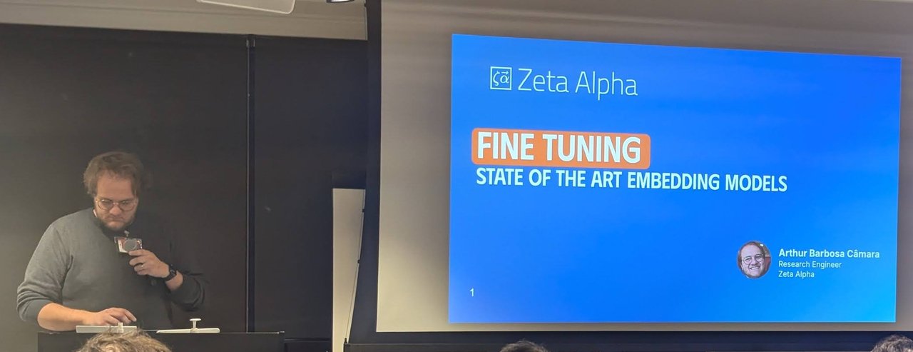 Arthur Barbosa CĂąmara presenting Fine Tuning State of the Art Embedding Models with the Zeta Alpha title slide