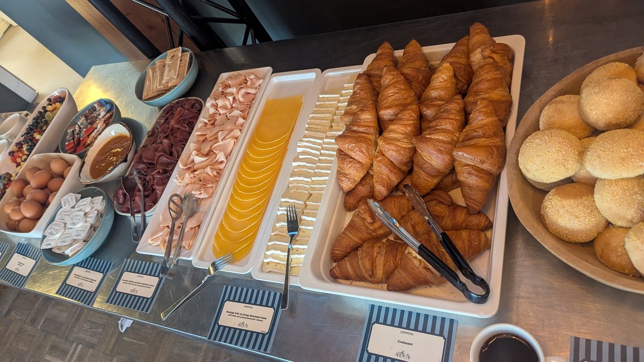 Breakfast buffet at OpenShift Commons Gathering Amsterdam 2026 with croissants, bread rolls, cheese and cold cuts