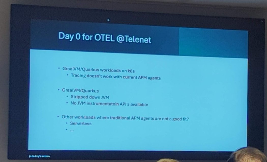 Speaker beside a slide titled Day 0 for OTEL @Telenet with bullets on GraalVM and Quarkus workloads on Kubernetes, a stripped-down JVM with no instrumentation APIs, and other workloads where traditional APM agents are not a good fit, such as serverless