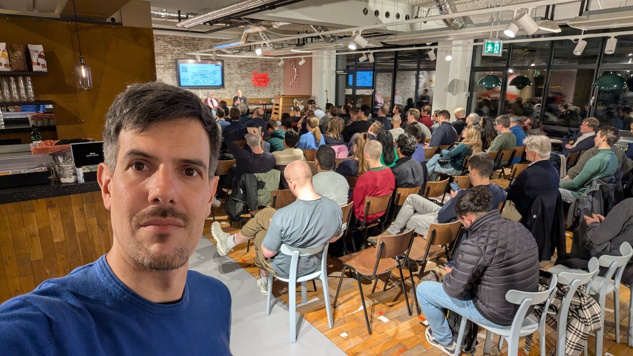 Audience at the Picnic developer experience meetup in Amsterdam, with the Slido word cloud on a screen at the front