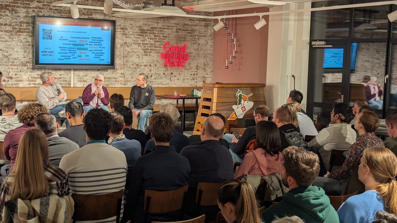 Developer experience panel at Picnic in Amsterdam with three panellists and the Slido question What metrics can be used to quantify DevEx on the screen