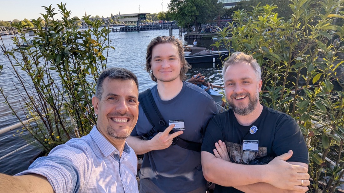 Networking with fellow attendees along the Amsterdam waterfront near Hannekes Boot