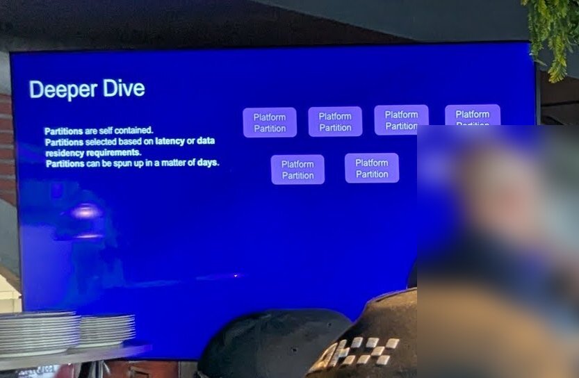 A slide titled Deeper Dive: partitions are self contained, selected based on latency or data residency requirements, and can be spun up in a matter of days