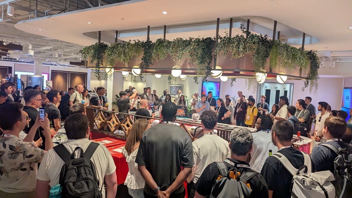 Evening booth crawl at PlatformCon London 2026 with Harness's 'AI for Everything After Code' banner