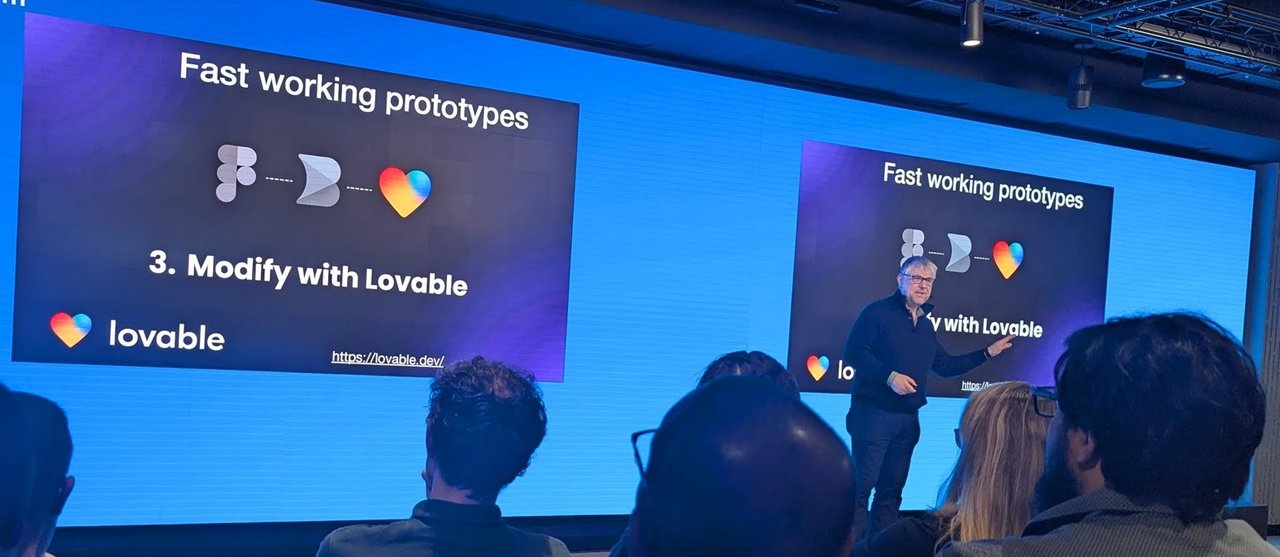 Slide titled Fast working prototypes showing a design-to-code flow ending in step 3, Modify with Lovable, with the speaker standing next to the screen