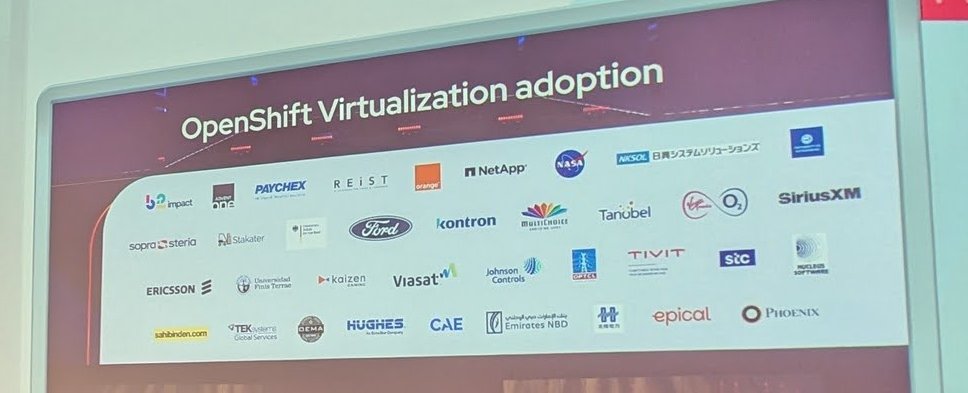 Keynote slide titled OpenShift Virtualization adoption, showing customer logos including Ford, NASA, Ericsson, Paychex, NetApp and SiriusXM