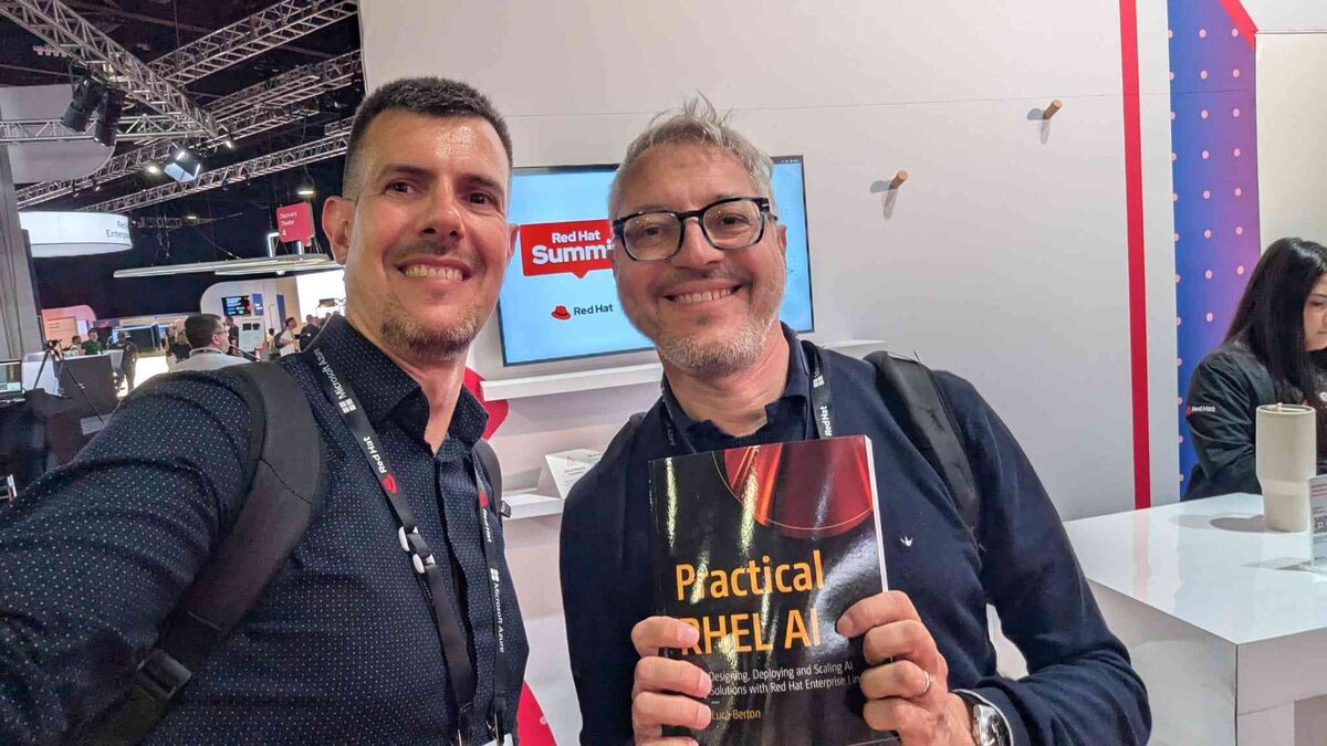 Attendee holding Practical RHEL AI at Red Hat Summit