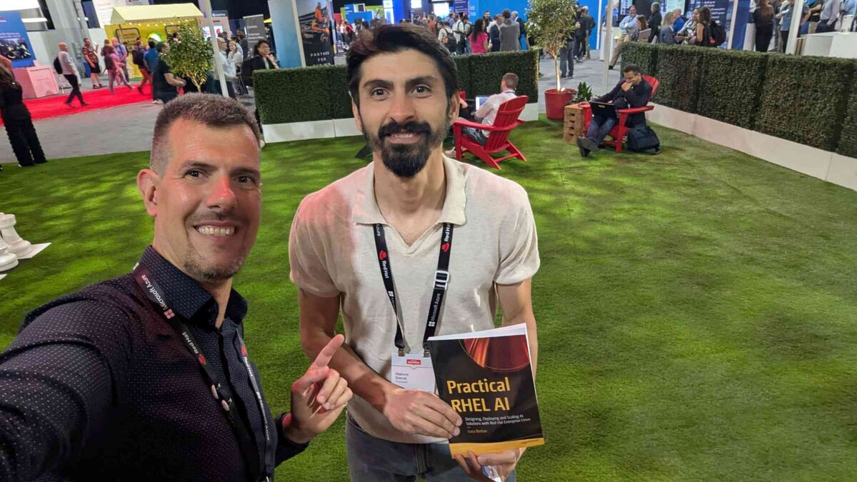 Dell Services team holding four copies of Practical RHEL AI at Red Hat Summit 2026