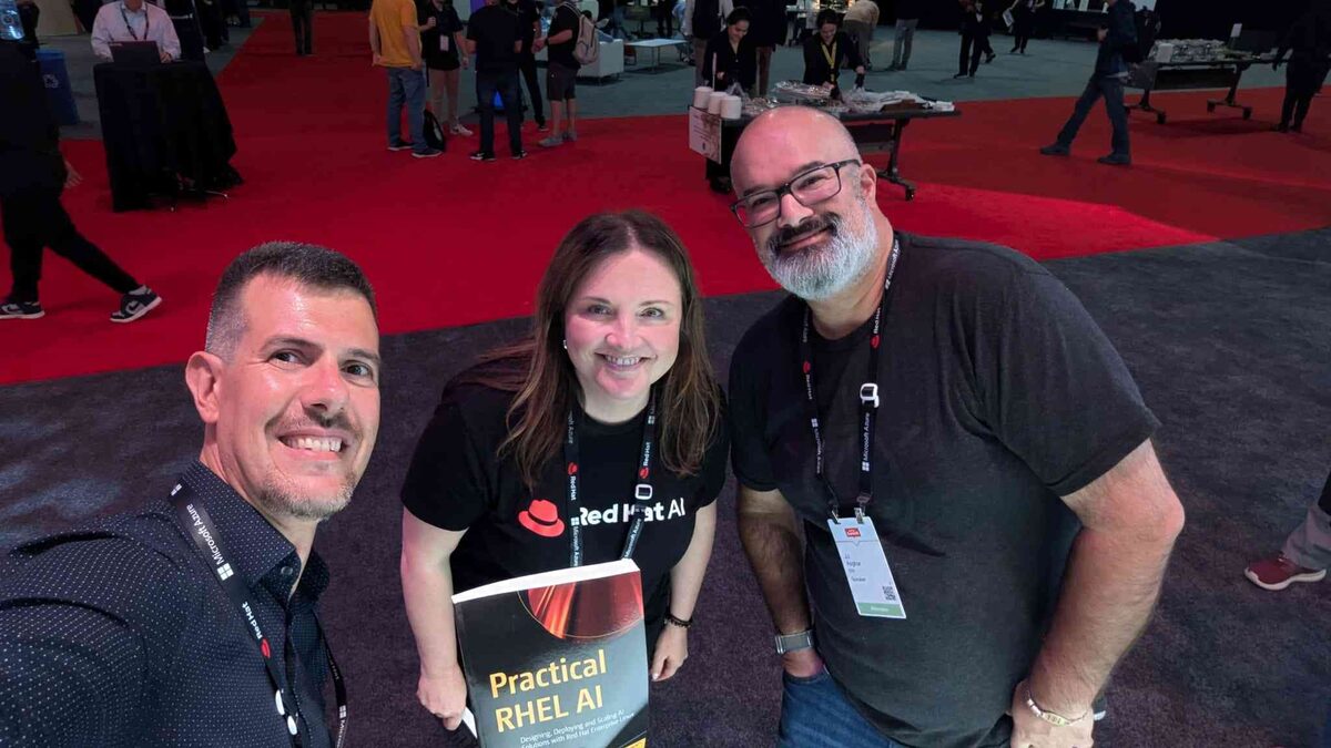 JJ Asghar from IBM holding Practical RHEL AI at Red Hat Summit