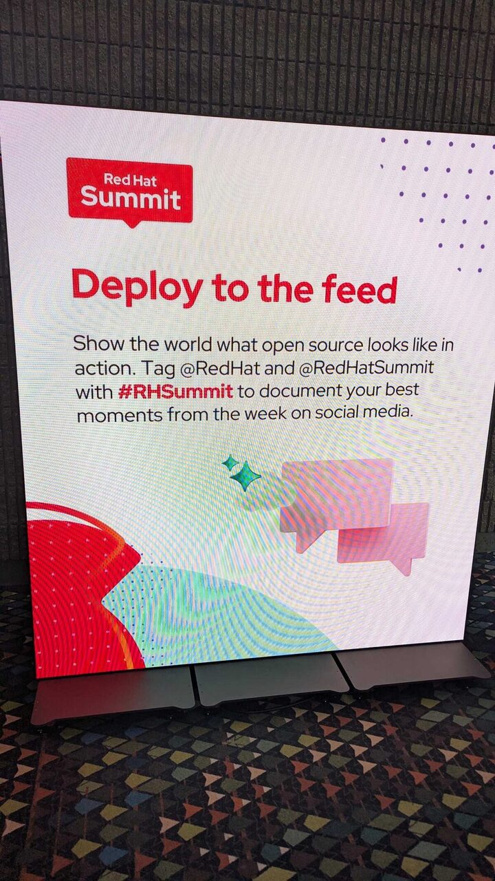 Red Hat Summit 2026 — Deploy to the Feed sign close-up