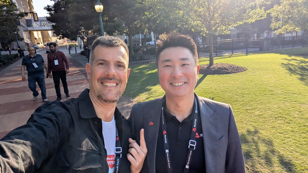 Jeff Lo, Portfolio Manager at Red Hat, with Luca Berton outside the Georgia World Congress Center at Red Hat Summit 2026