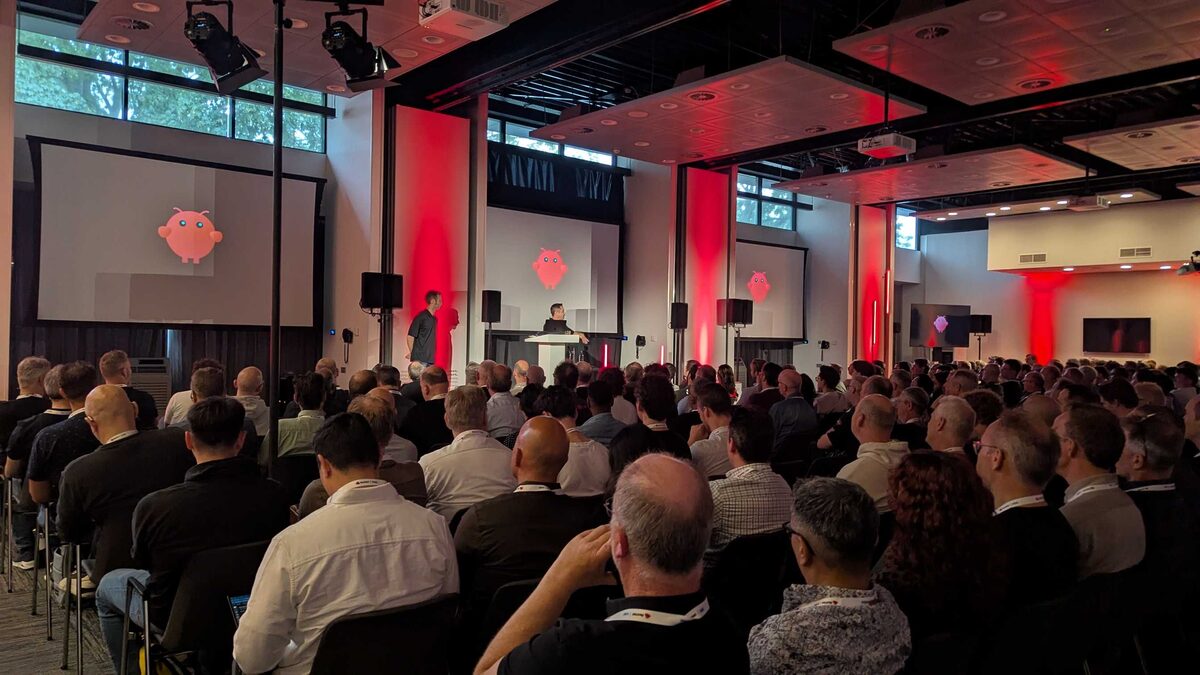 Wide shot of brain-in-jar slide with packed audience