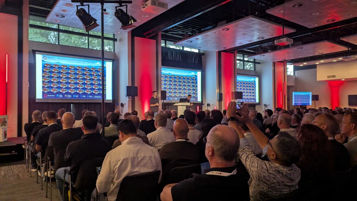 Audience taking photos of the OpenClaw pods demo — packed room