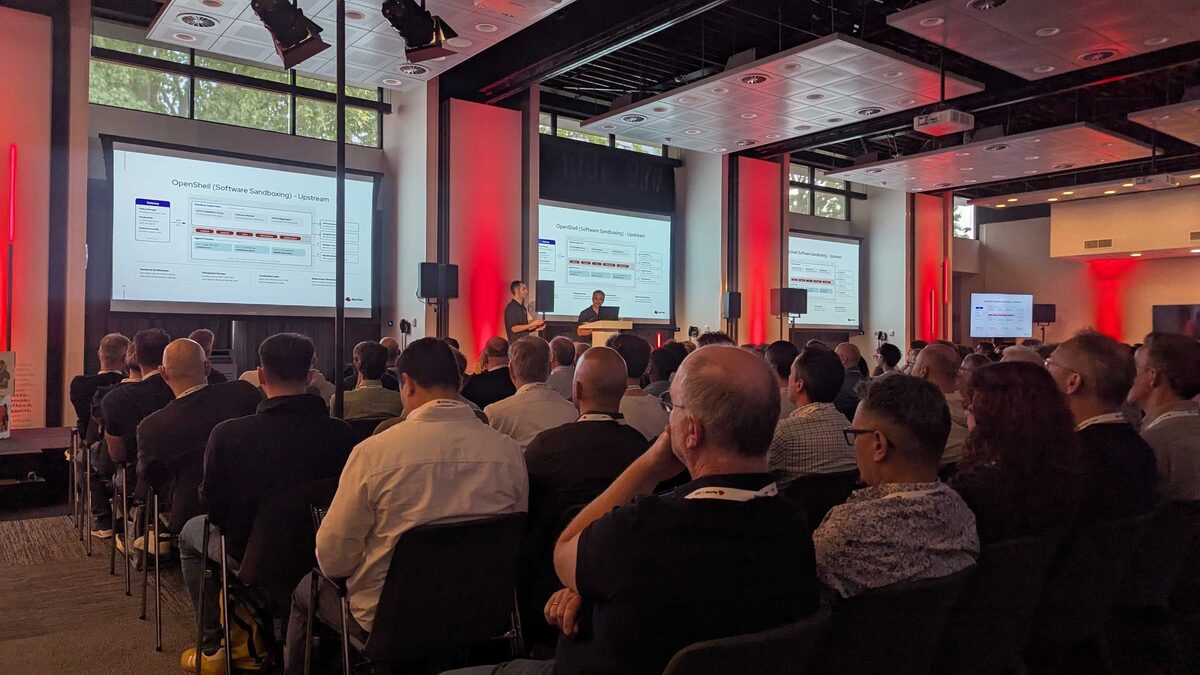 Wide shot of OpenShift topology demo — audience engaged