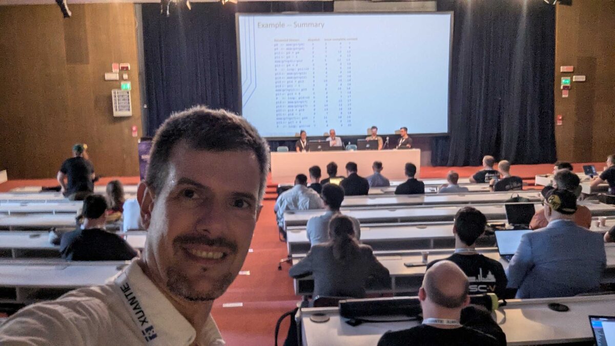 Selfie in the RISC-V Summit auditorium during technical session on out-of-order pipeline execution