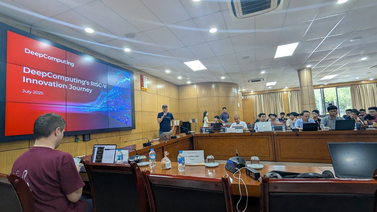 The DeepComputing title slide, July 2025, on the screen at the front of the hall while the speaker stands with a microphone
