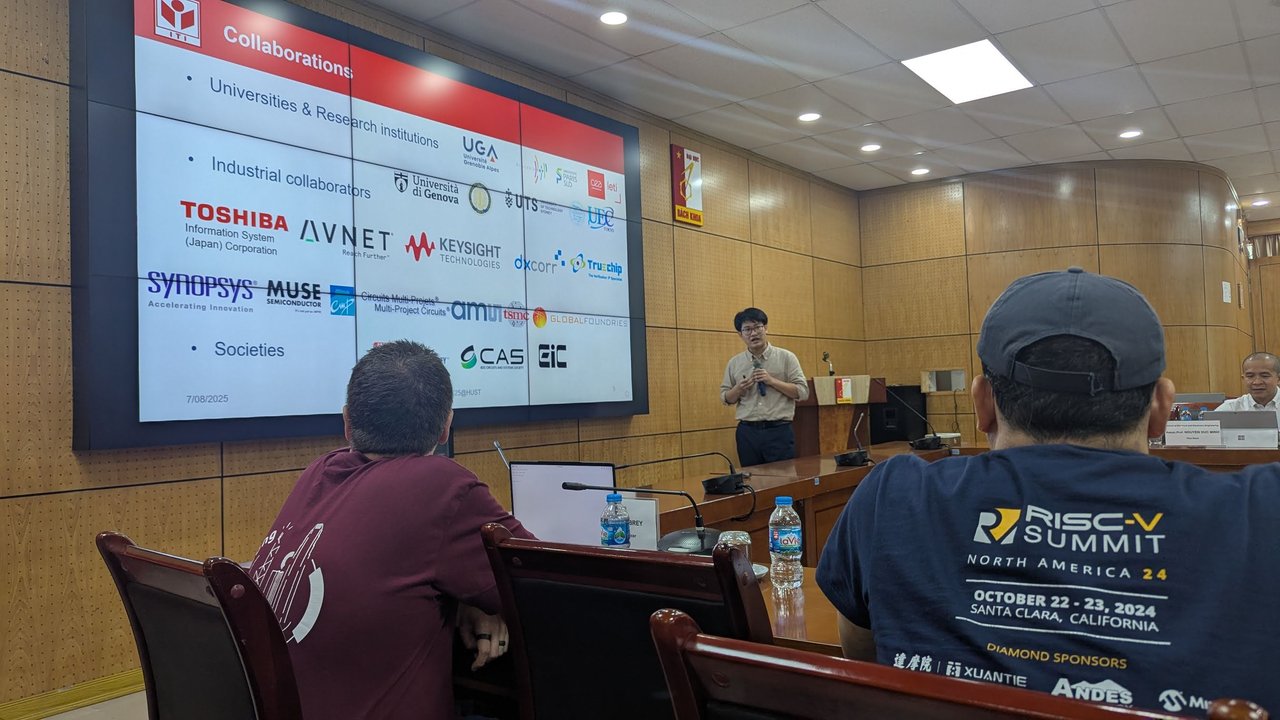 A collaborations slide with university, industry and society logos, with the presenter standing at the lectern