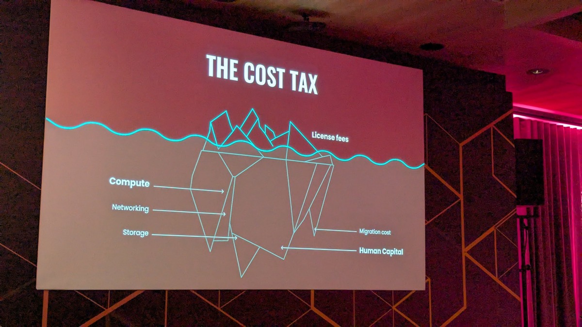 Spencer Kimball's keynote slide 'The Cost Tax' showing compute, networking, storage, migration cost, and human capital as an iceberg at RoachFest London 2026