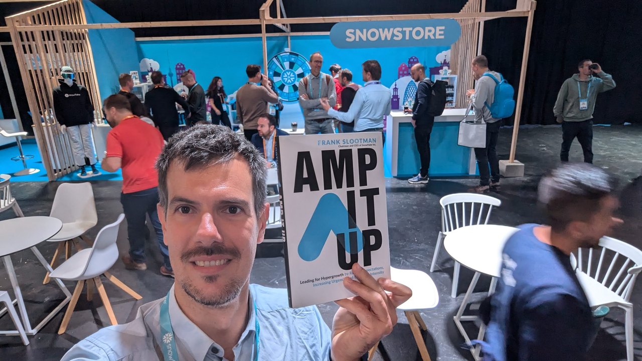 Luca Berton at the Snowstore at Snowflake World Tour Amsterdam 2024, holding a copy of Amp It Up