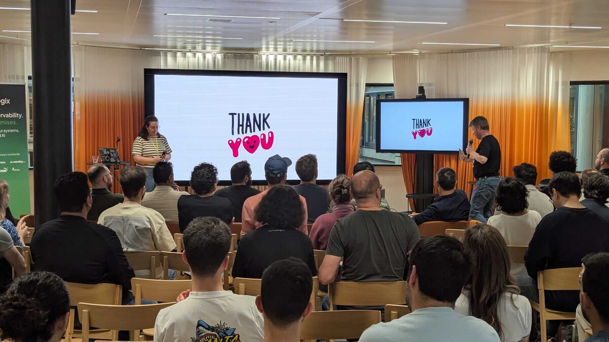 Thank You — Iris Dyrmishi and Lewis Isaac closing the talks to a packed room at Miro Amsterdam