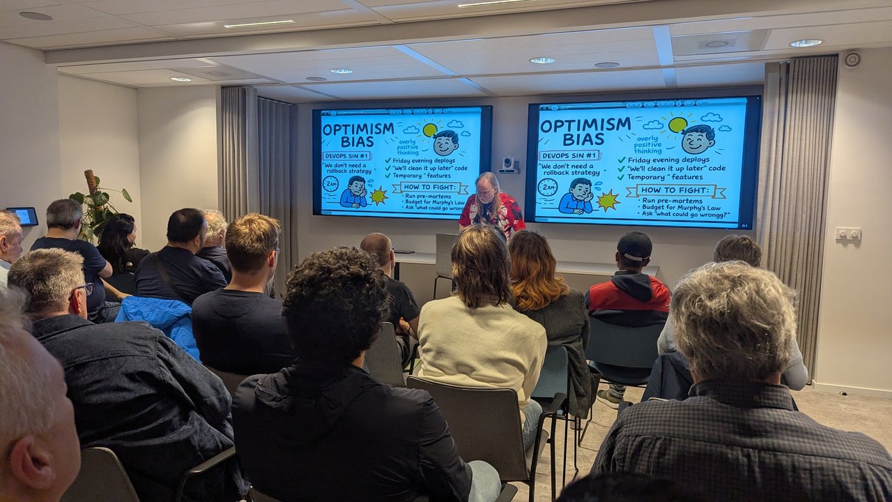 Optimism Bias slide at the SRE NL meetup listing Friday evening deploys, clean it up later code and temporary features, with pre-mortems as the fix