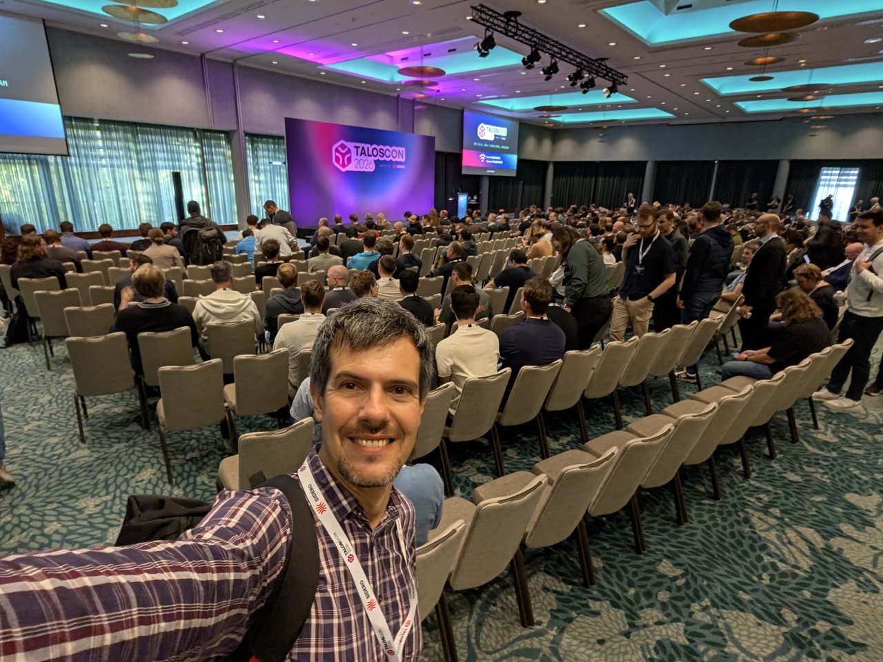 A full Grand Ballroom at Hotel Okura before the opening keynote, with Luca in the foreground