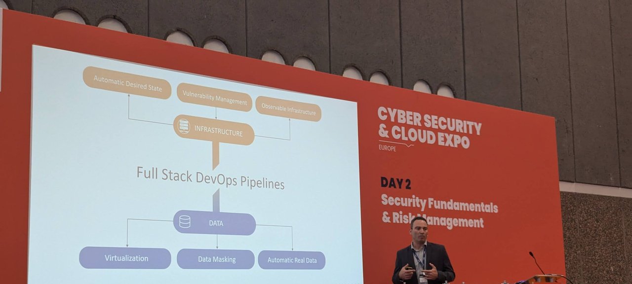 Slide: Full Stack DevOps Pipelines, with infrastructure and data branches, and the speaker at the lectern