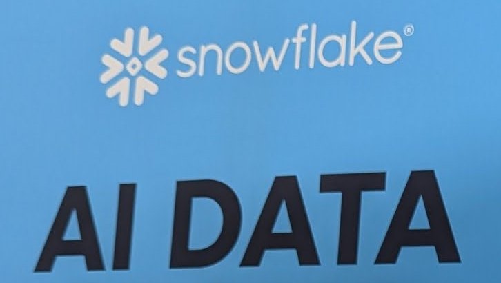 The Snowflake booth wall with the Snowflake logo and the words AI DATA