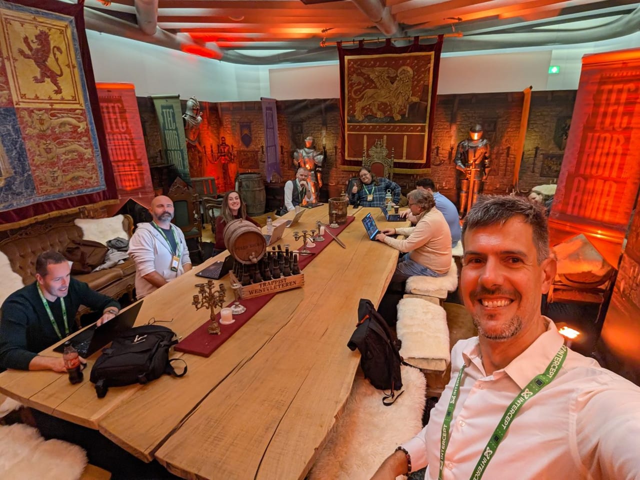 A hall at Techorama dressed as a medieval great hall, with banners, armour and a long wooden table