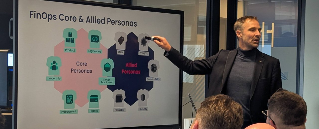 The FinOps Core and Allied Personas slide: product, engineering, leadership, FinOps practitioner, procurement and finance as core personas, with ITAM, ITSM, ITFM and security as allied personas, with the speaker pointing at the slide
