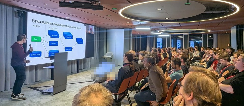 Ed Schouten presenting the Typical Buildbarn based remote execution cluster slide: Bazel and output base at desk, bb-frontend, bb-storage, bb-scheduler, bb-worker and bb-portal in the cloud
