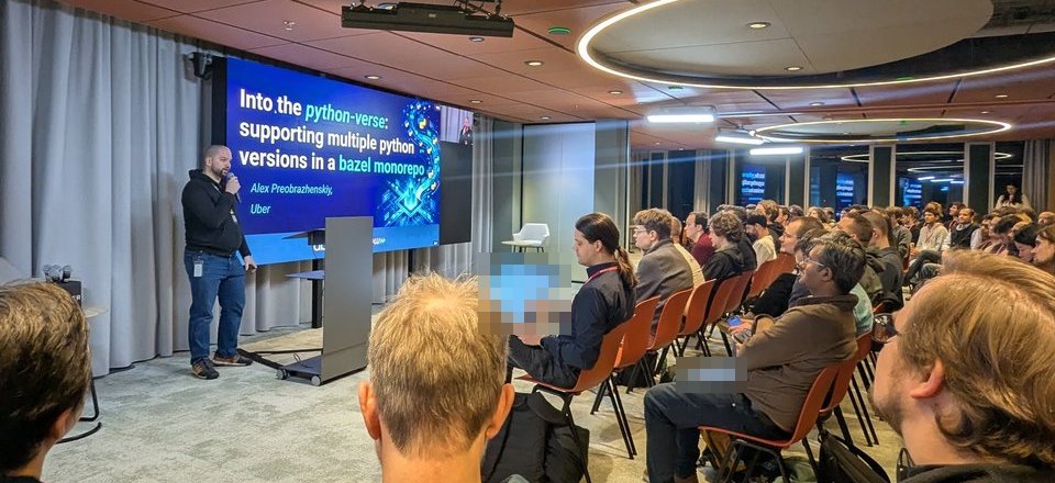 Alex Preobrazhenskiy from Uber presenting the title slide Into the python-verse: supporting multiple python versions in a bazel monorepo