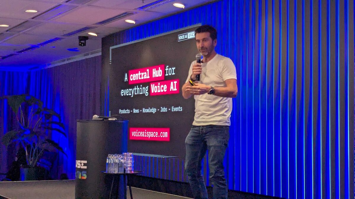 Voice AI Space presenter on stage — voiceaispace.com central hub for everything Voice AI