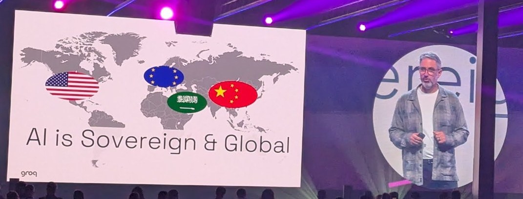 Groq slide on the World Summit AI main stage: AI is Sovereign and Global, with US, EU, Saudi and Chinese flags on a world map, and the speaker on the big screen