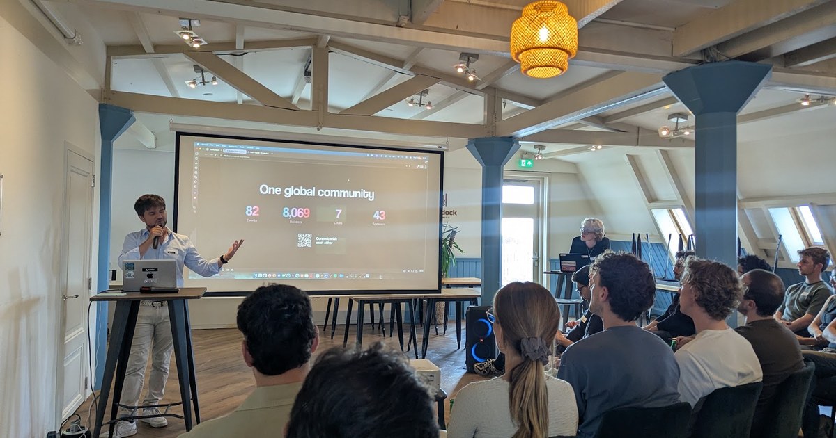 AI Builders Amsterdam meetup at StartDock Coworking, with a speaker presenting to the audience