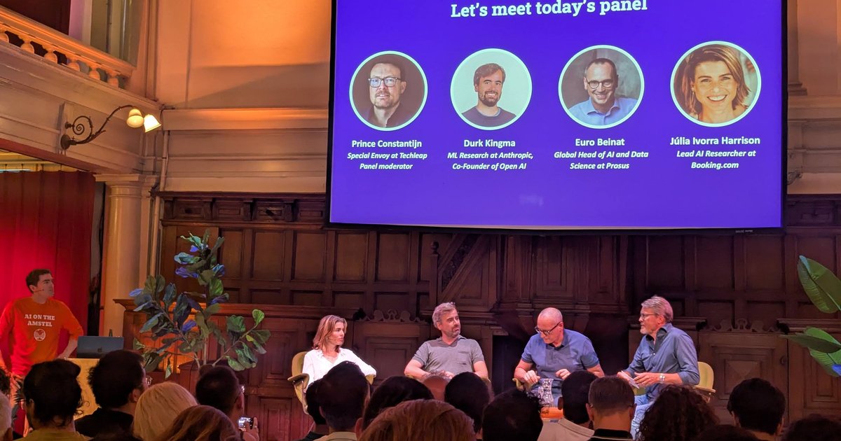 Panel slide at AI on the Amstel in Amsterdam with four panellists seated on stage below it