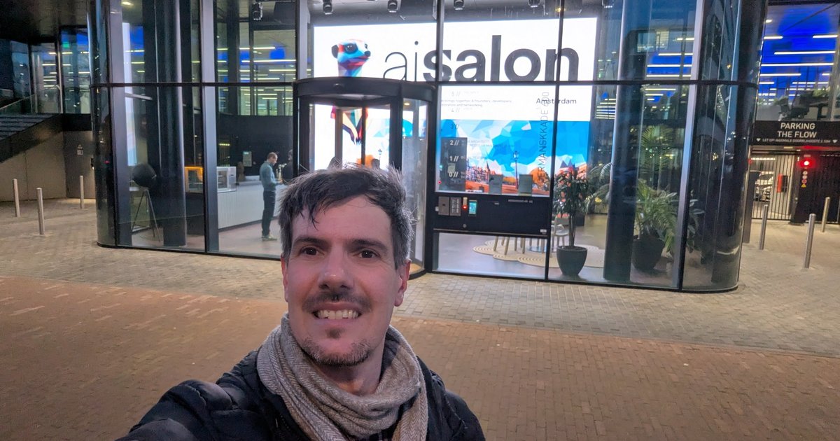 Luca Berton outside The Flow in Amsterdam Houthavens, with the aisalon Amsterdam screen in the window behind him