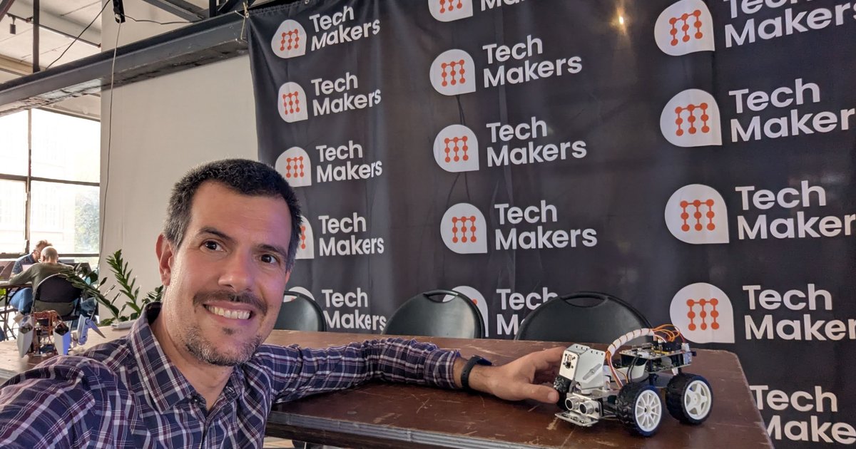 Luca Berton at the Tech Makers Top Bot Hackathon in Amsterdam with a small Raspberry Pi robot car on the table