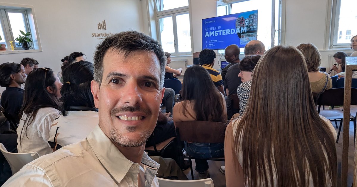 Luca Berton at the Mindstone AI Meetup Amsterdam at Startdock in July 2024, with the meetup welcome slide behind him