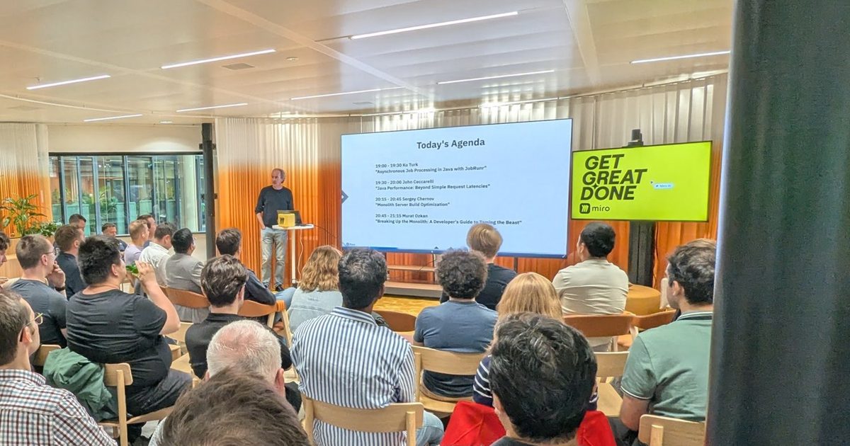 Audience at the Amsterdam JUG meetup facing a Today's Agenda slide with four Java talks, next to a Miro Get Great Done screen