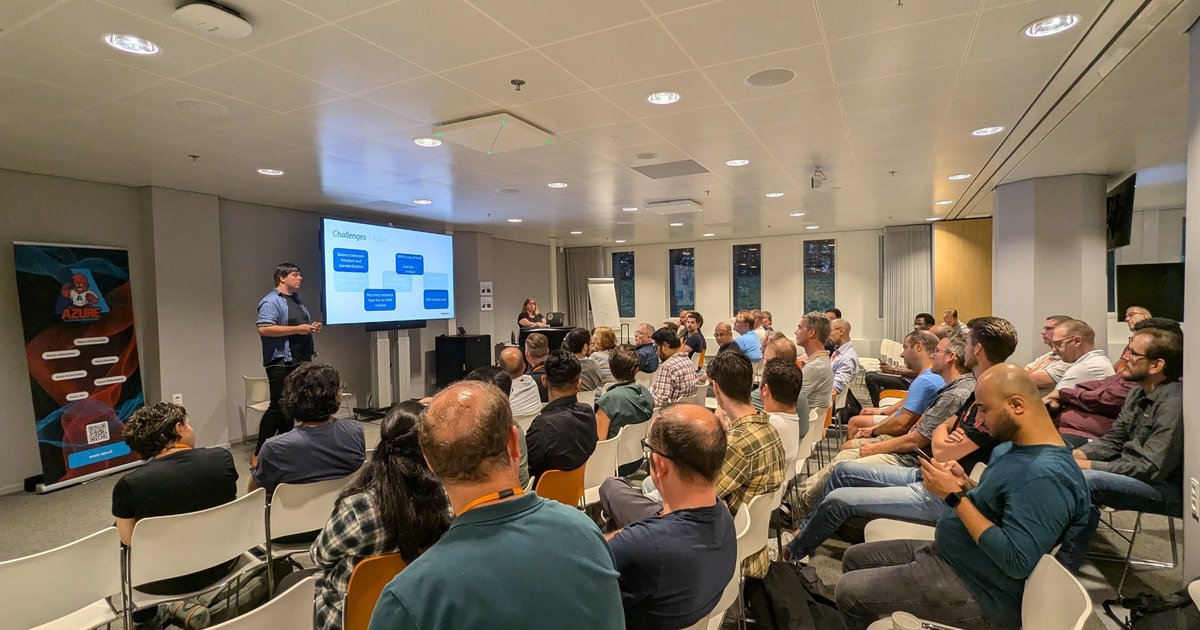 A full meeting room at the Azure Platform Engineering meetup in Utrecht, with a Challenges slide on the screen
