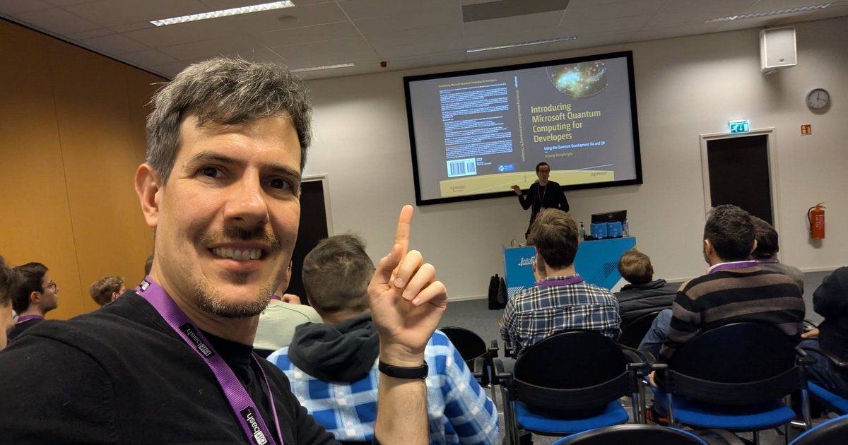 Luca Berton at BitBash 2025 in Veenendaal, pointing at the Introducing Microsoft Quantum Computing for Developers slide behind him