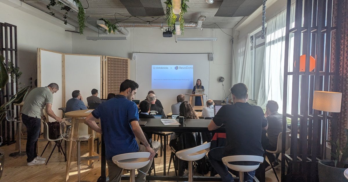 Attendees at the Databricks and RevoData Fundamentals Bootcamp in Amsterdam, with the welcome slide on the screen