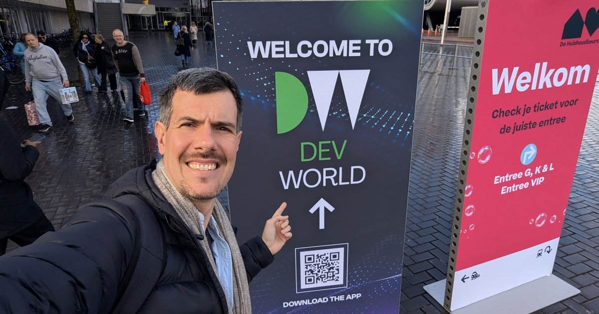 Luca Berton pointing at the Welcome to DevWorld sign outside RAI Amsterdam in February 2025