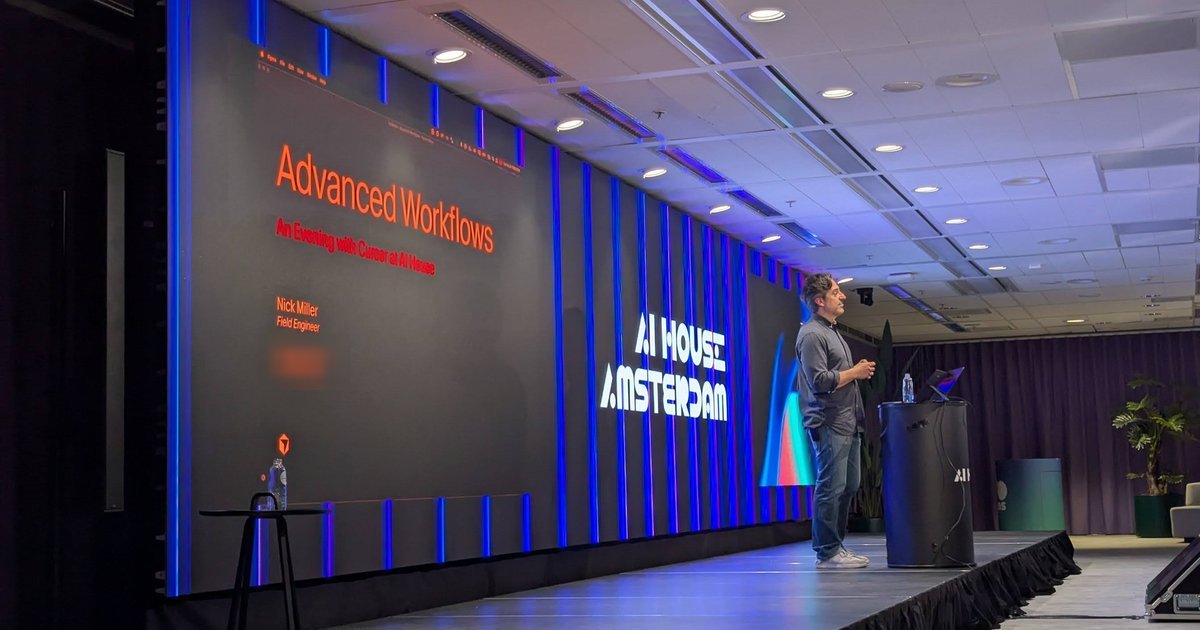 Nick Miller on stage at AI House Amsterdam next to the Advanced Workflows: An Evening with Cursor at AI House title slide