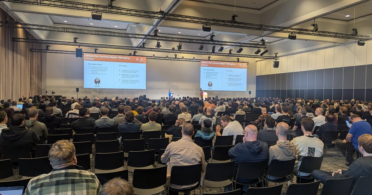A packed session hall at KubeCon + CloudNativeCon Europe 2026 in Amsterdam, with a slide on the move from Jenkins to Tekton